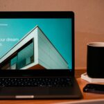 a laptop computer sitting on top of a wooden desk